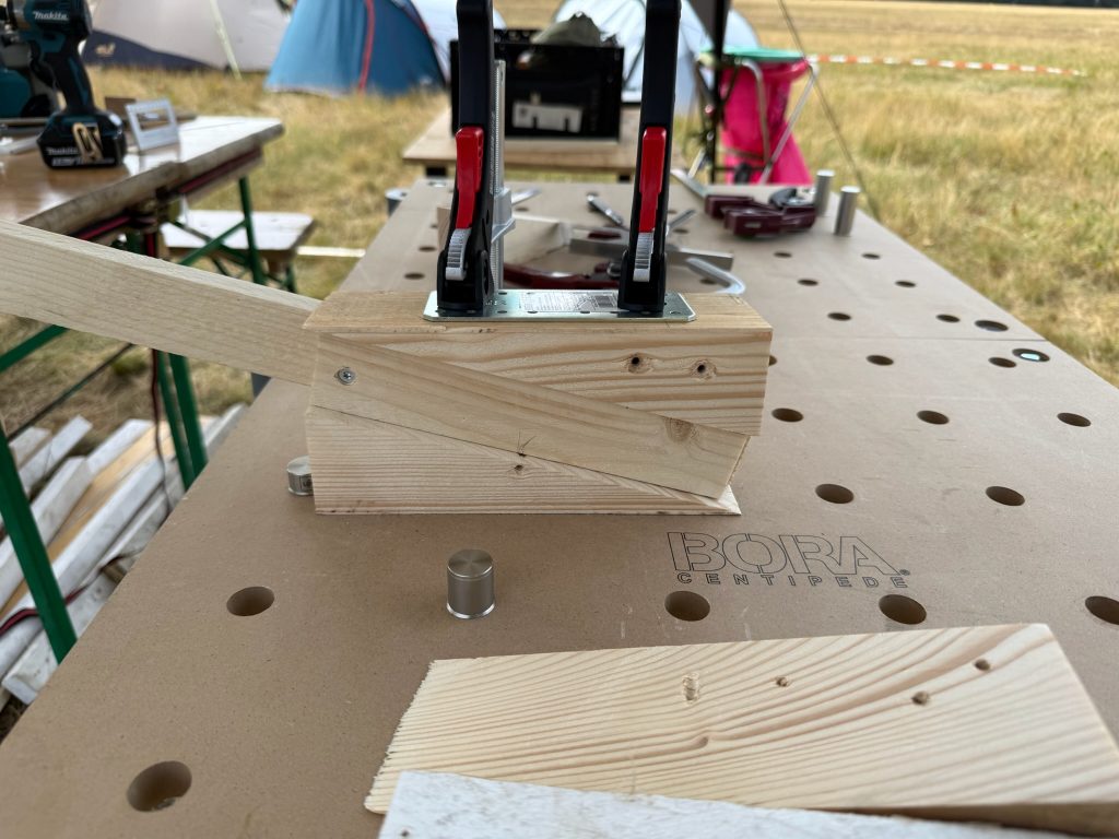 Clamped arm assembly with top and bottom wedge